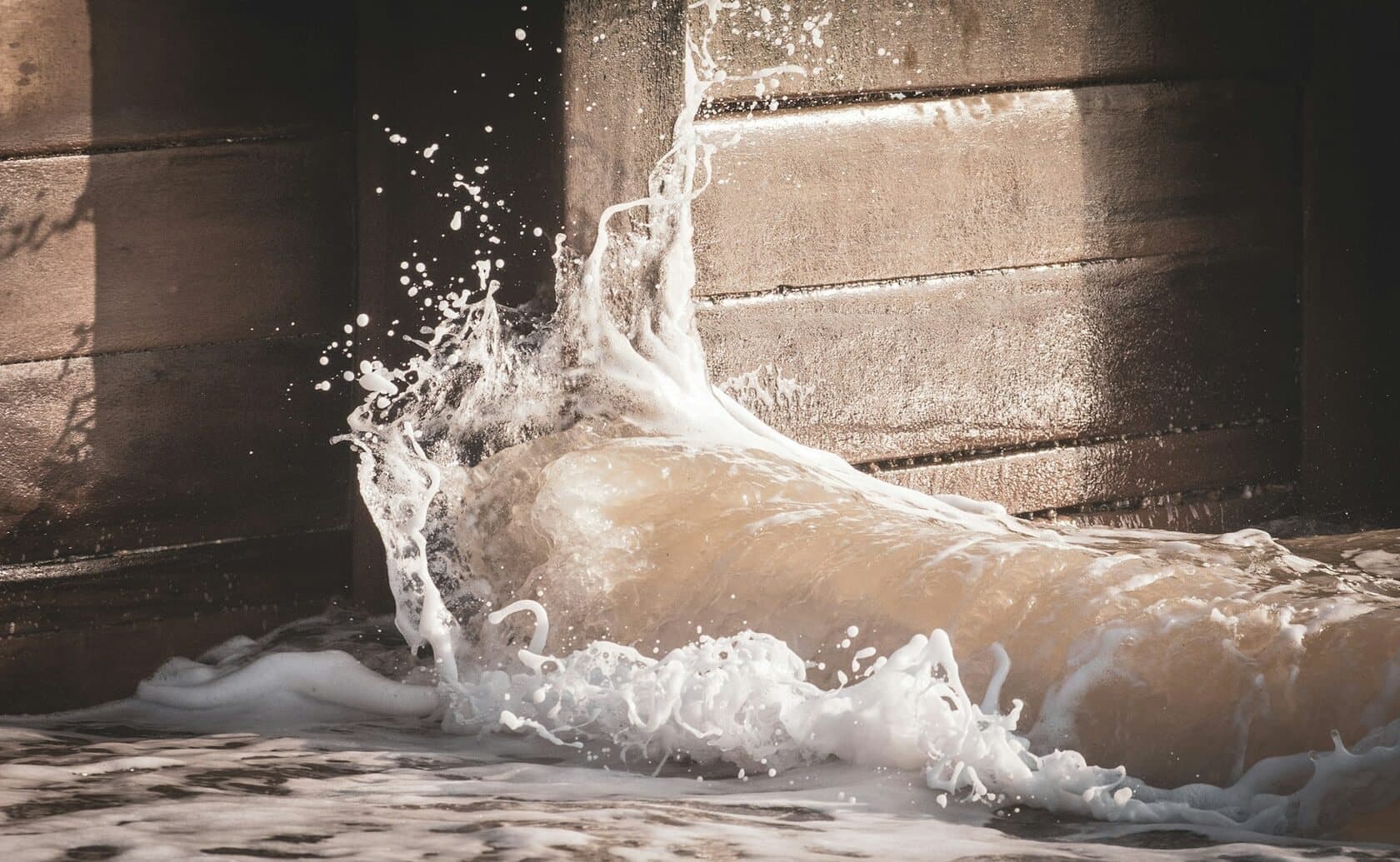 Floodwater surging against a wall