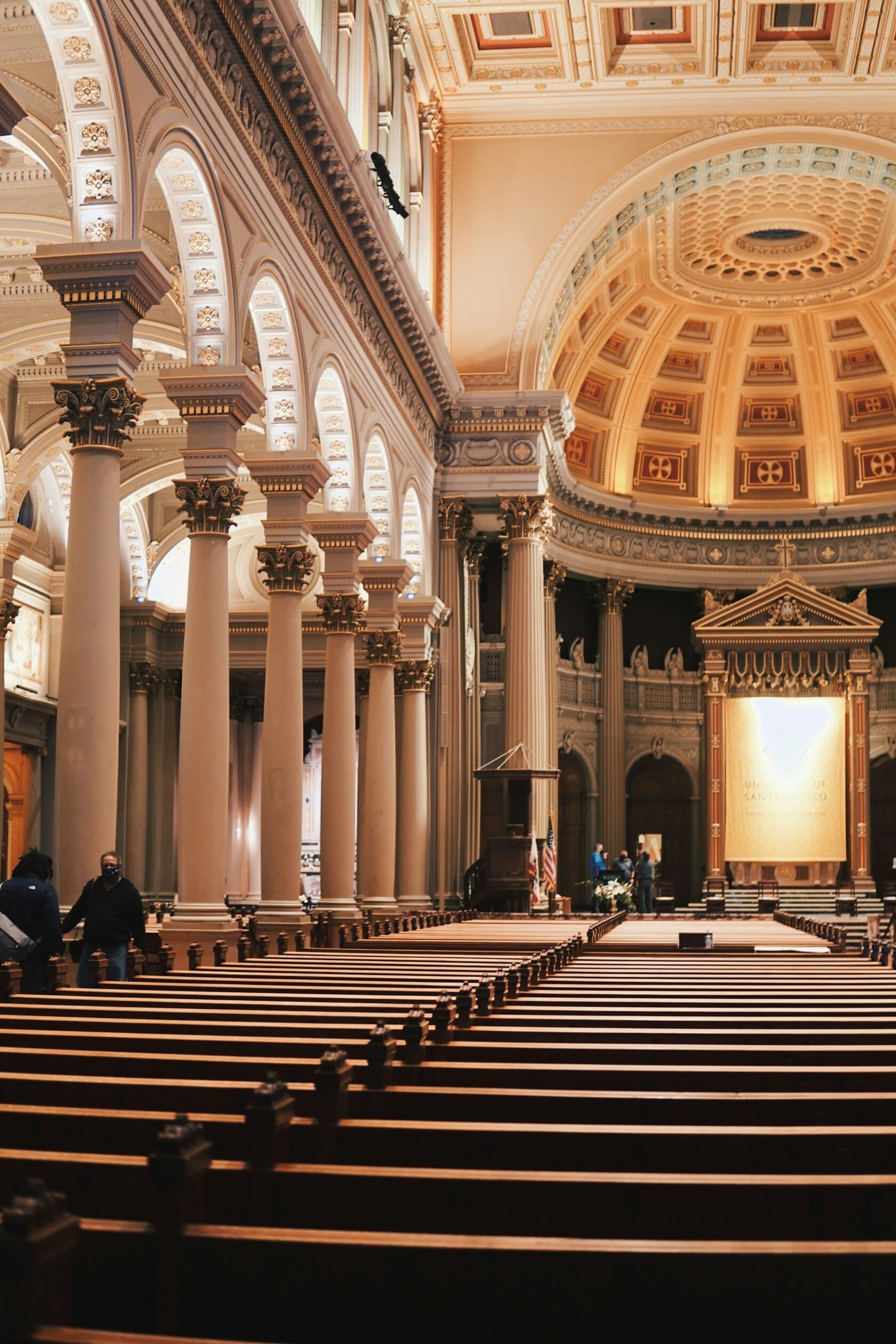 Interior of a church with wooden pews and a domed ceiling