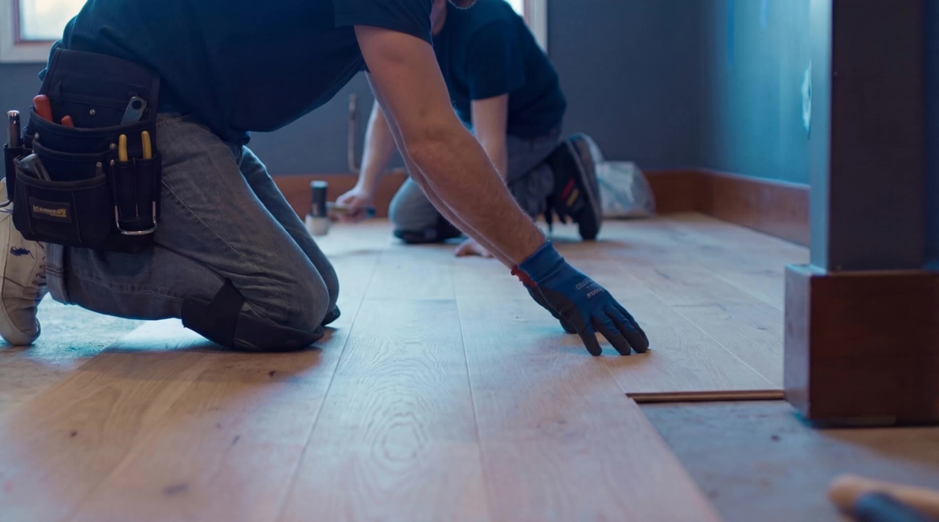 An RMO installer fitting new hardwood flooring