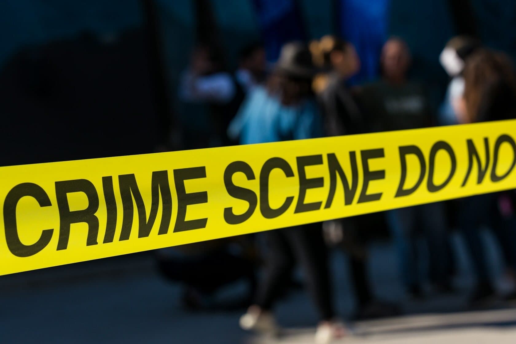 Yellow crime scene tape across a closed-off area