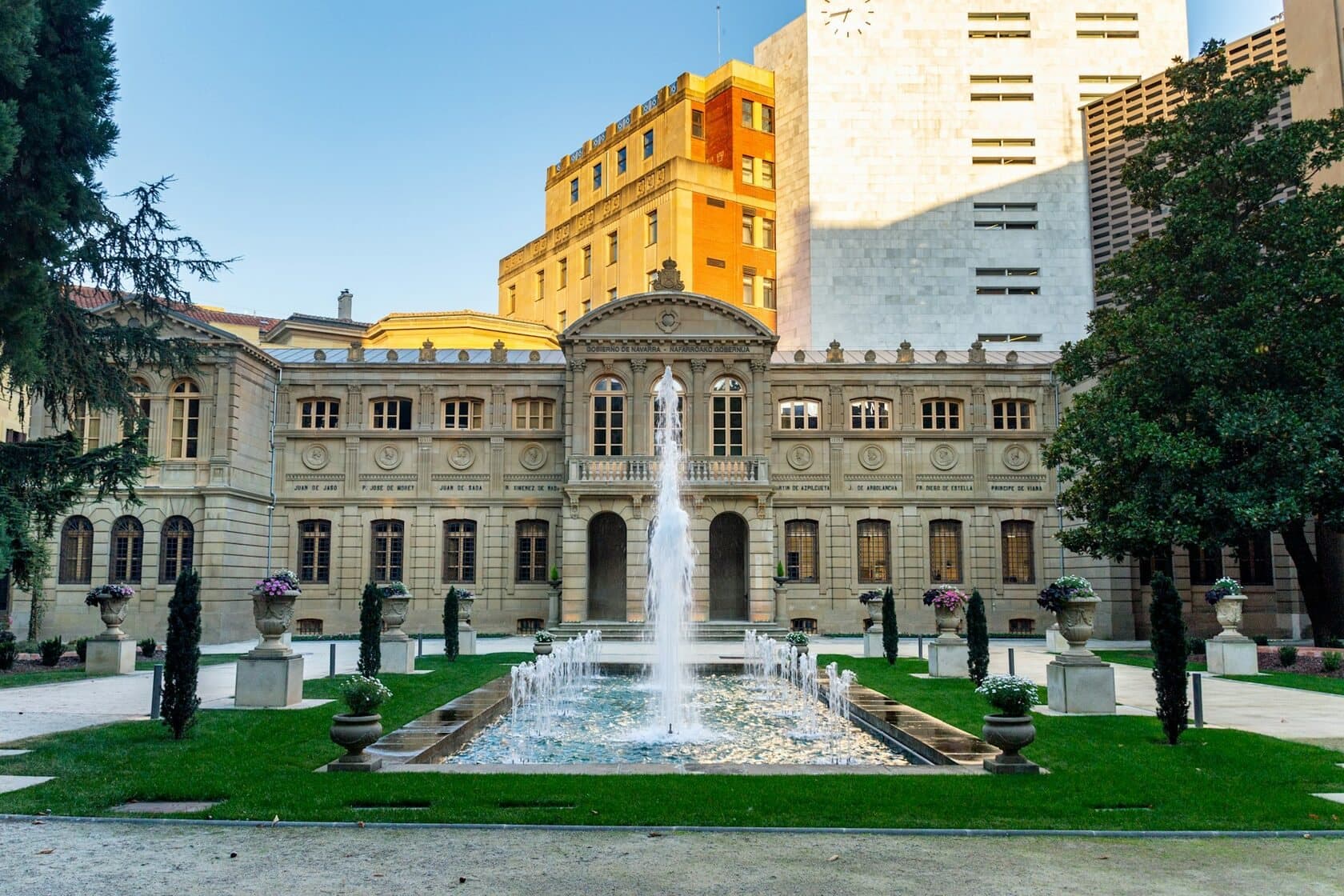 Historic government building with a fountain in front
