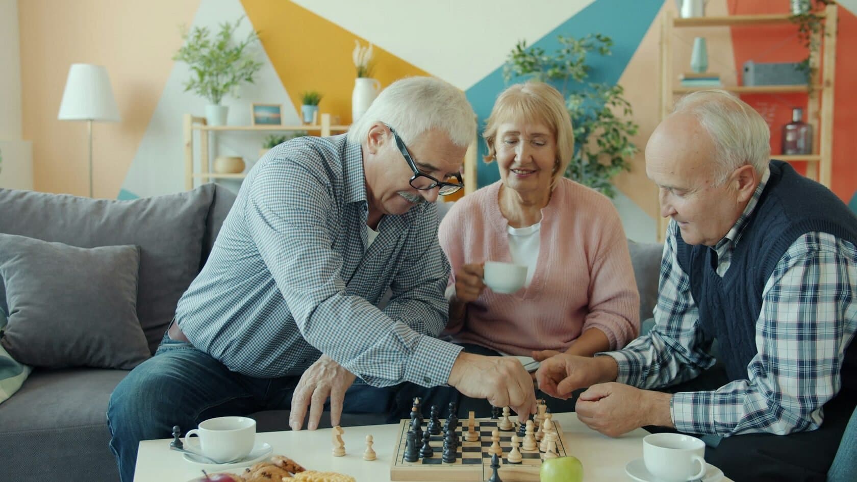 Residents playing chess in a senior living common room