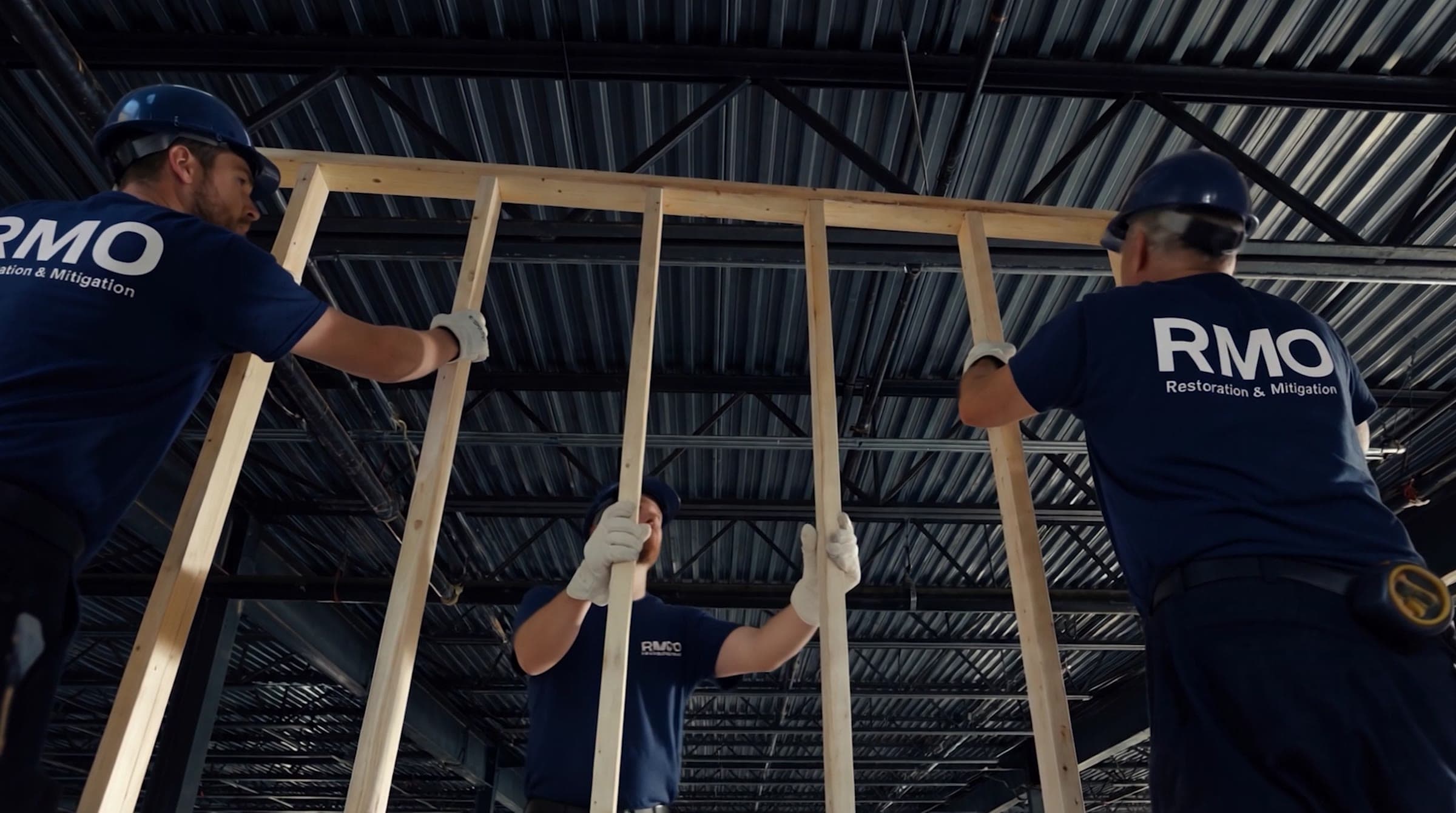 RMO crew raising new wall framing during a rebuild