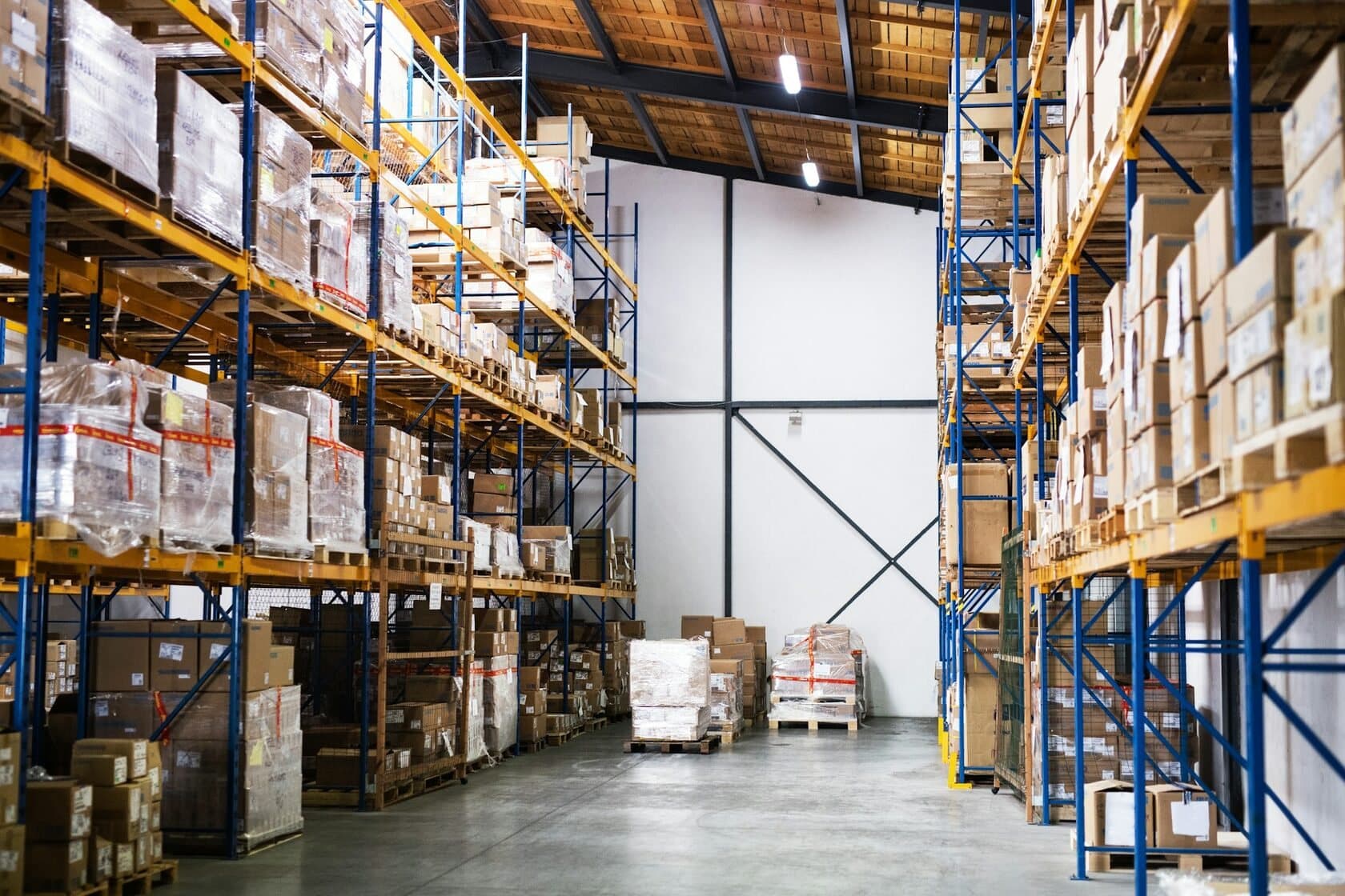 Tall racking stocked with pallets inside a distribution warehouse